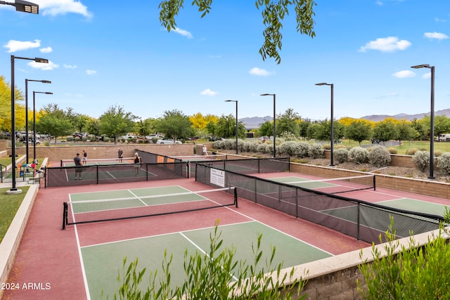 view of tennis court featuring a mountain view