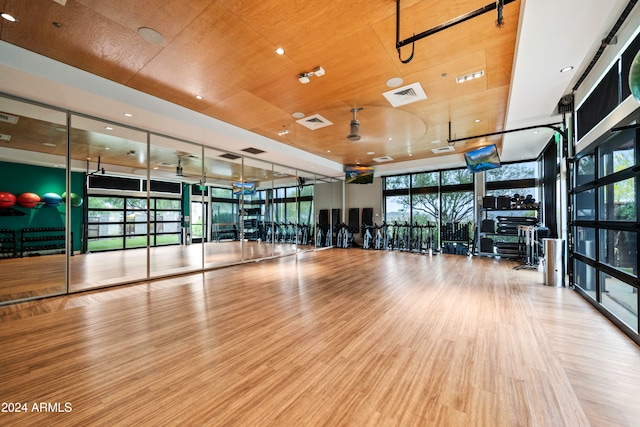 workout area with hardwood / wood-style flooring and floor to ceiling windows