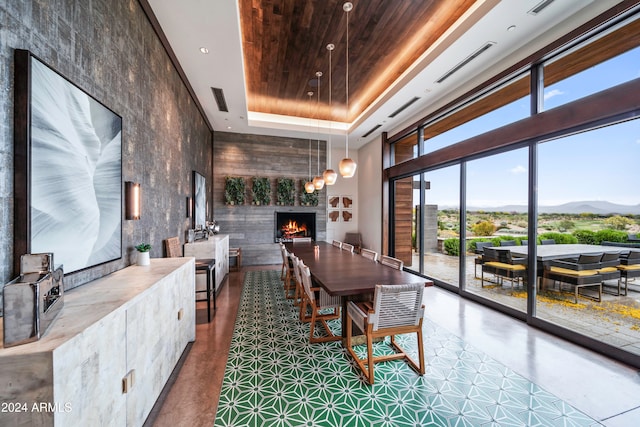 dining room with a mountain view, a towering ceiling, and a tray ceiling