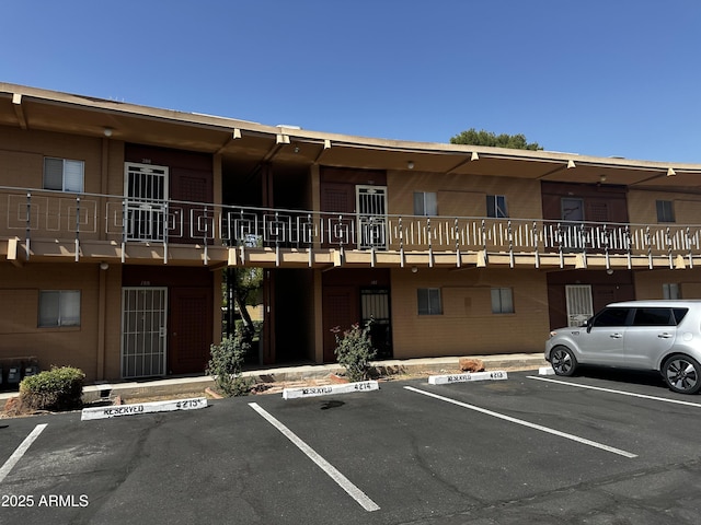 view of building exterior with uncovered parking