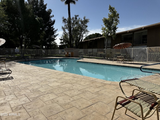 community pool featuring a patio area and fence