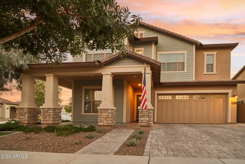 view of front of property featuring a porch and a garage