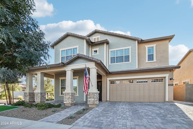 craftsman inspired home featuring covered porch and a garage