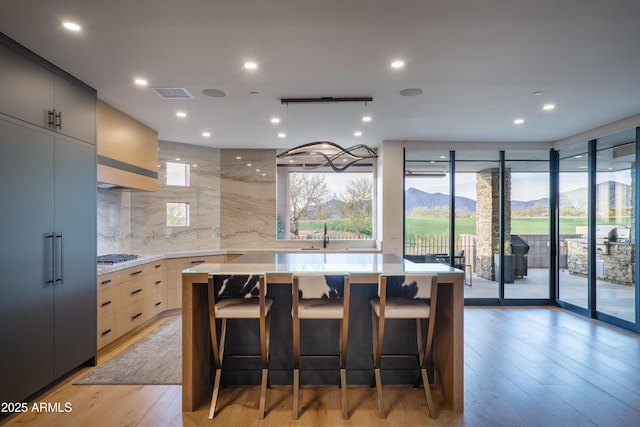 kitchen featuring a large island, a mountain view, and a kitchen bar