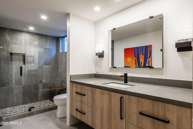 bathroom with an enclosed shower, vanity, tile patterned floors, and toilet