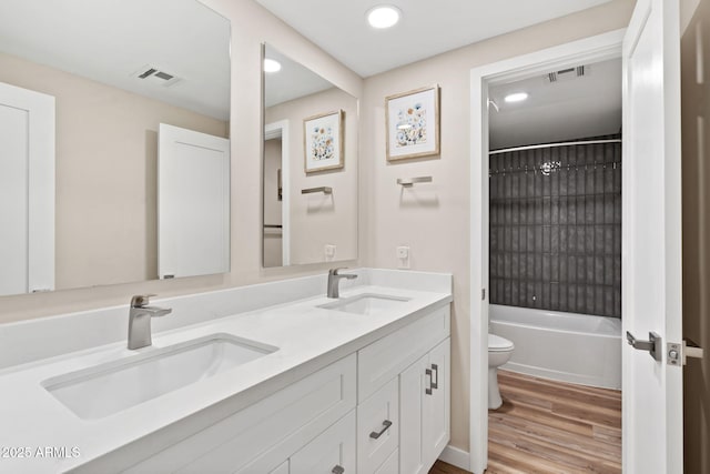 5833 N 10th St, Phoenix, AZ 85014 - bathroom featuring double vanity, wood finished floors, recessed lighting, and tub / shower combination