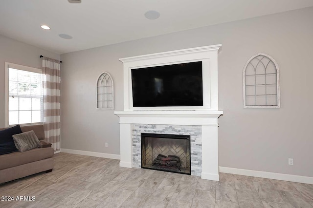 living room featuring a tile fireplace