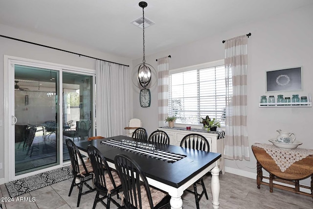 dining area with a chandelier and light tile patterned floors