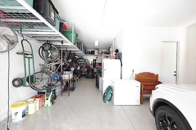 garage featuring white fridge and refrigerator