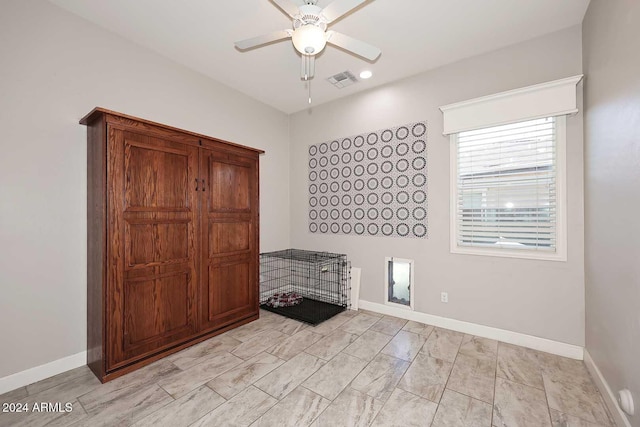 interior space with ceiling fan