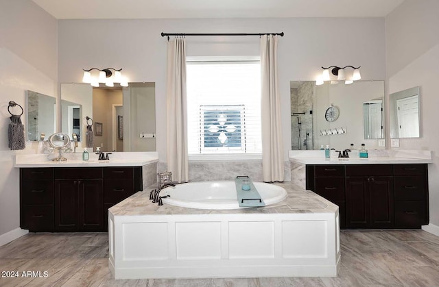 bathroom with vanity and a bath