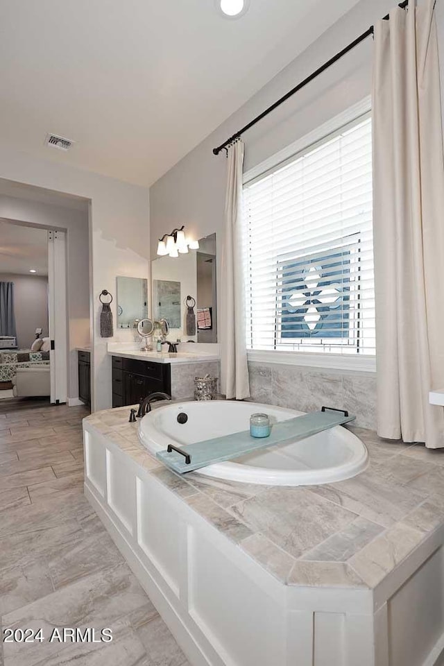 bathroom featuring vanity and a bathing tub