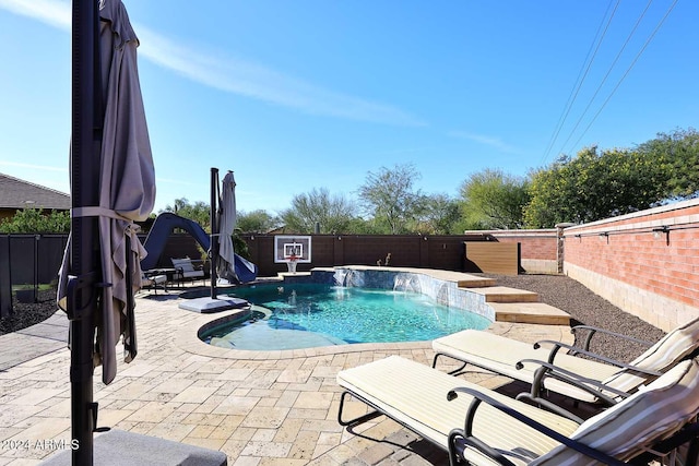 view of pool with pool water feature and a patio area