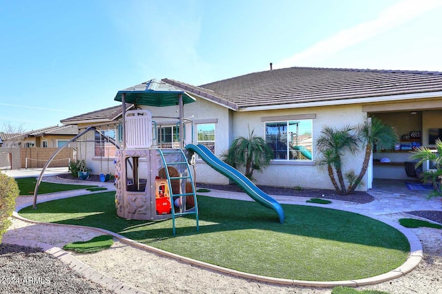 view of playground with a lawn