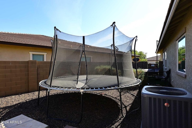 exterior space featuring central AC and a trampoline