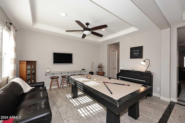 game room with pool table, ceiling fan, a wealth of natural light, and a tray ceiling