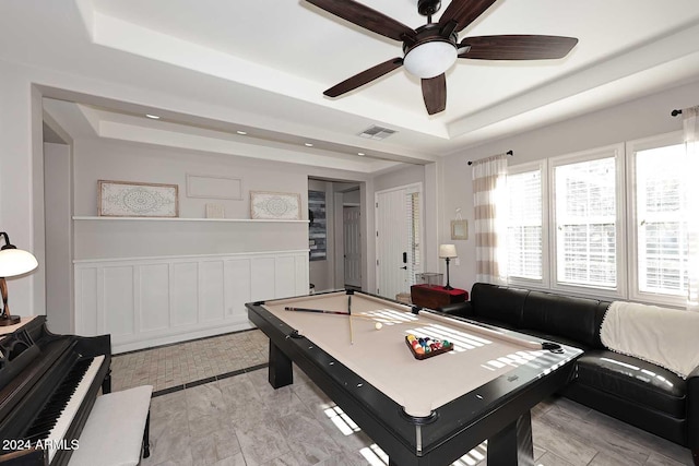 rec room featuring a tray ceiling, ceiling fan, and billiards