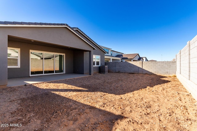 back of property featuring central AC and a patio