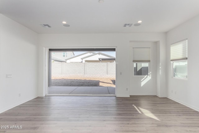 spare room with light hardwood / wood-style floors