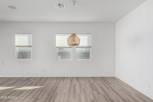 spare room with light hardwood / wood-style flooring