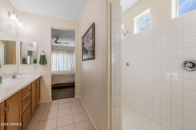 bathroom with a wealth of natural light, tile patterned flooring, connected bathroom, and a sink