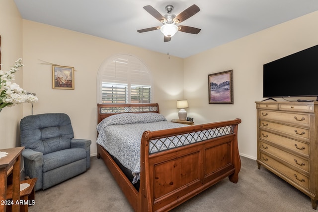 bedroom with light carpet, ceiling fan, and baseboards