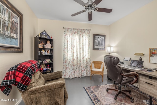 office with concrete floors and ceiling fan