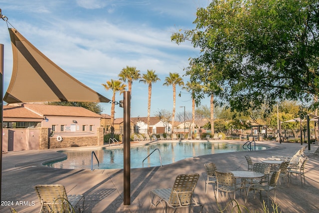 pool featuring a patio area and fence