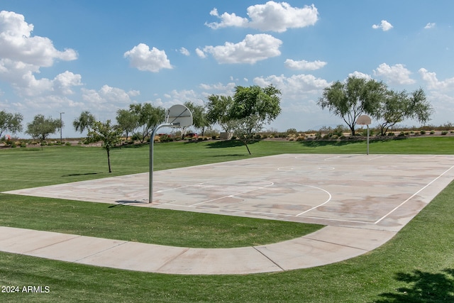 view of basketball court with community basketball court and a lawn