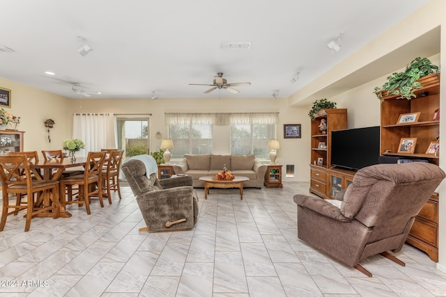 living area featuring marble finish floor, visible vents, and ceiling fan