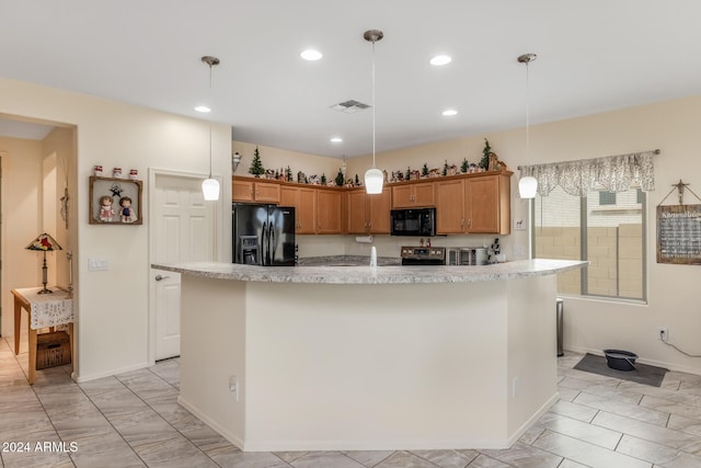 kitchen with a center island with sink, decorative light fixtures, and black appliances