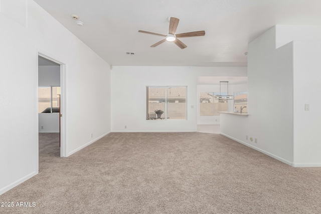 unfurnished living room featuring ceiling fan and light colored carpet