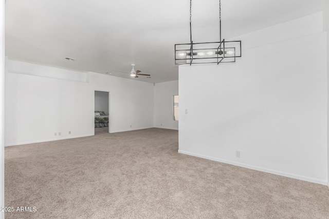 spare room with ceiling fan and carpet