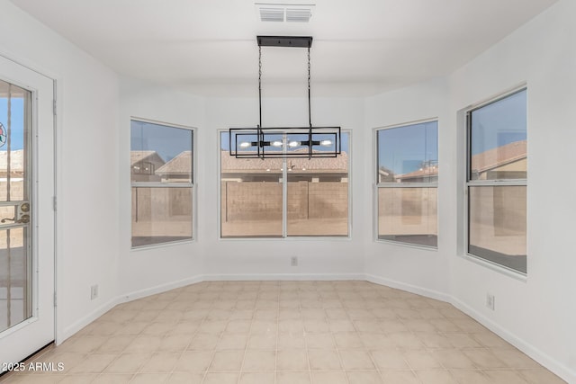 unfurnished dining area with a chandelier