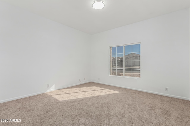 spare room featuring light colored carpet