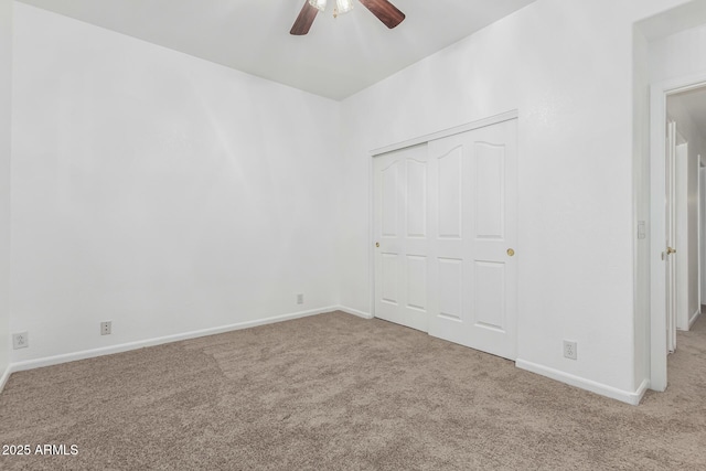 unfurnished bedroom featuring ceiling fan, light carpet, and a closet