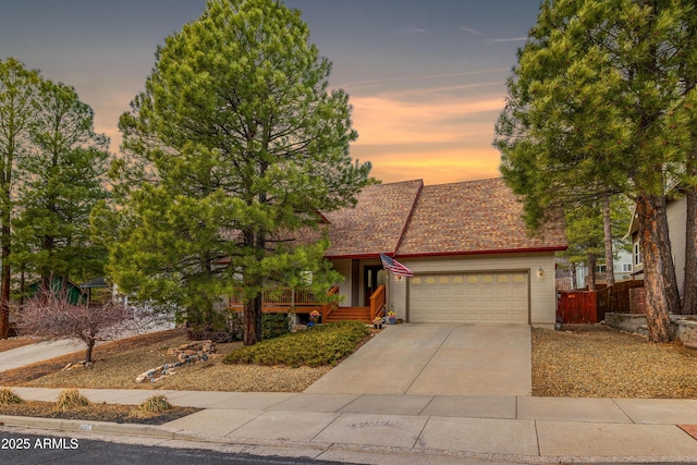 630 W Cattle Drive Trl, Flagstaff, AZ 86005 - view of front of home with driveway, fence, a garage, and roof with shingles