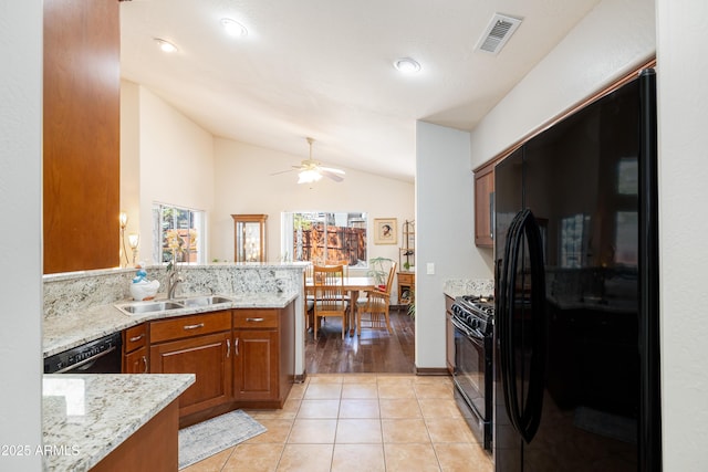 630 W Cattle Drive Trl, Flagstaff, AZ 86005 - kitchen with black appliances, visible vents, brown cabinets, lofted ceiling, and a sink