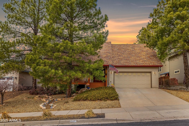 630 W Cattle Drive Trl, Flagstaff, AZ 86005 - view of property hidden behind natural elements with a garage, roof with shingles, and driveway
