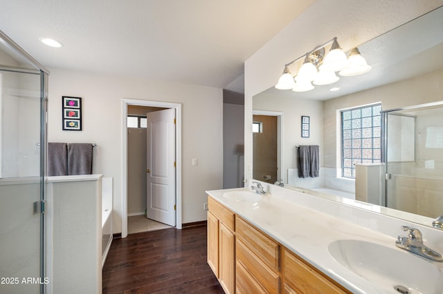 630 W Cattle Drive Trl, Flagstaff, AZ 86005 - bathroom with a sink, wood finished floors, and a garden tub