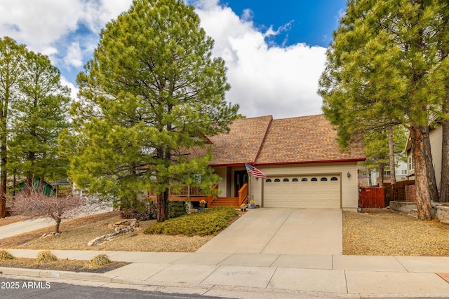 630 W Cattle Drive Trl, Flagstaff, AZ 86005 - view of front facade with a shingled roof, a garage, fence, and driveway