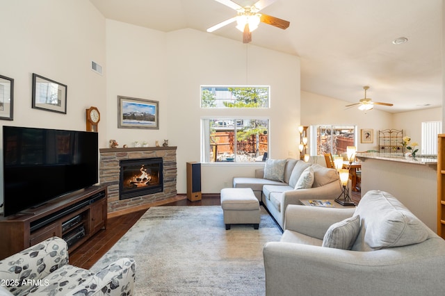 630 W Cattle Drive Trl, Flagstaff, AZ 86005 - living area featuring visible vents, a stone fireplace, a ceiling fan, and dark wood-style floors