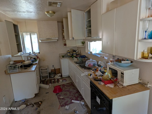 kitchen featuring sink and white cabinets