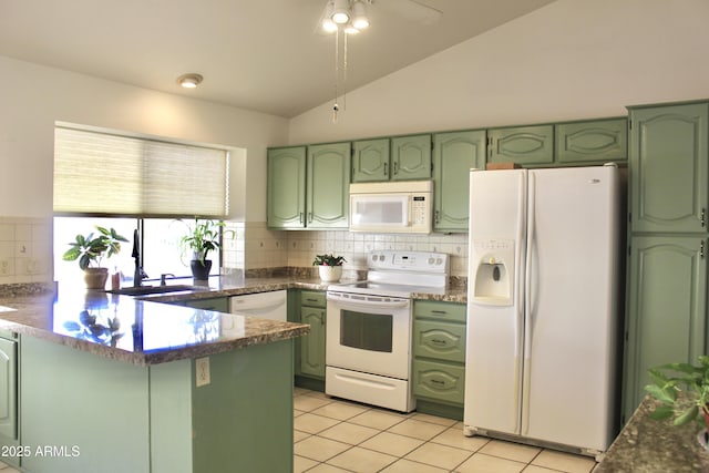 kitchen with white appliances, a peninsula, and green cabinets