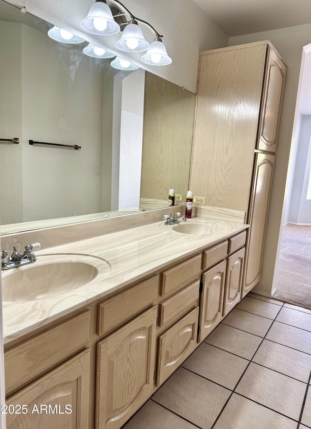 full bathroom with tile patterned floors, a sink, and double vanity