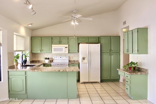 kitchen with visible vents, vaulted ceiling, a sink, white appliances, and a peninsula