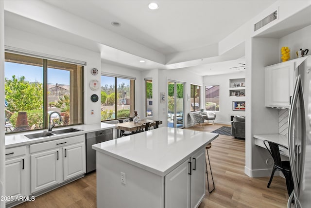 10415 E Rosemary Ln, Scottsdale, AZ 85255 - kitchen with a sink, appliances with stainless steel finishes, open floor plan, a center island, and recessed lighting