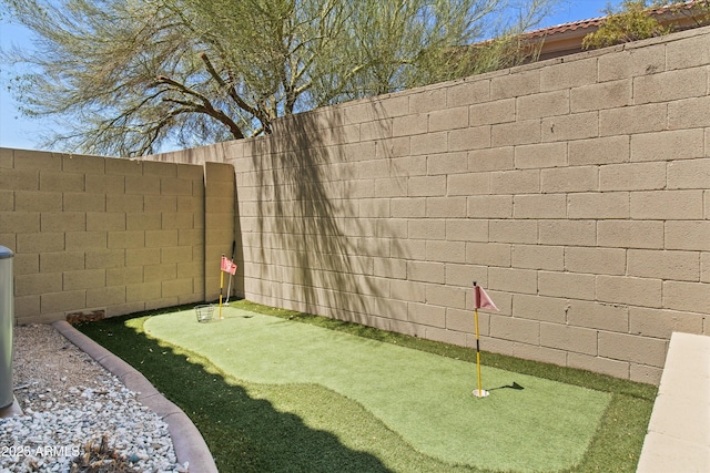 10415 E Rosemary Ln, Scottsdale, AZ 85255 - view of yard with a putting area and fence