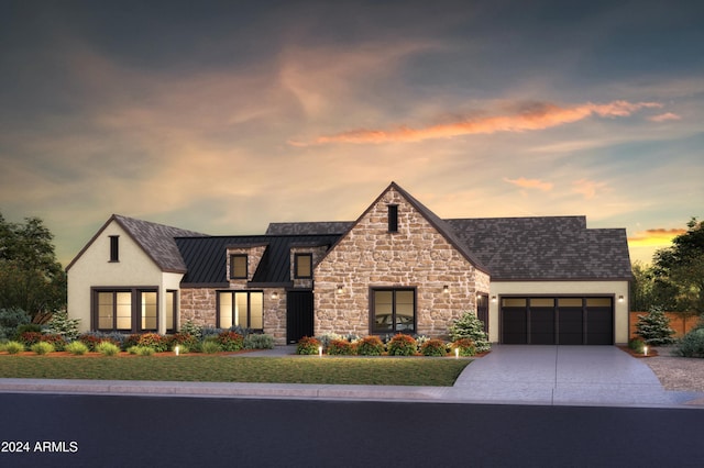 view of front of house featuring stucco siding, a standing seam roof, metal roof, a garage, and driveway