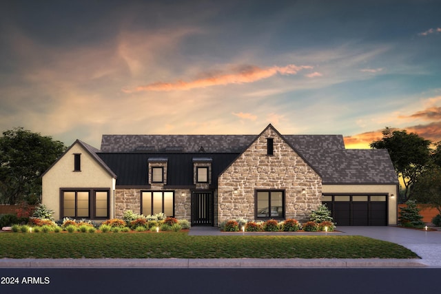 view of front of property with stucco siding, concrete driveway, a standing seam roof, metal roof, and a garage